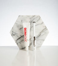 Load image into Gallery viewer, SKINBOLIC skincare product on a marble stand with a white background
